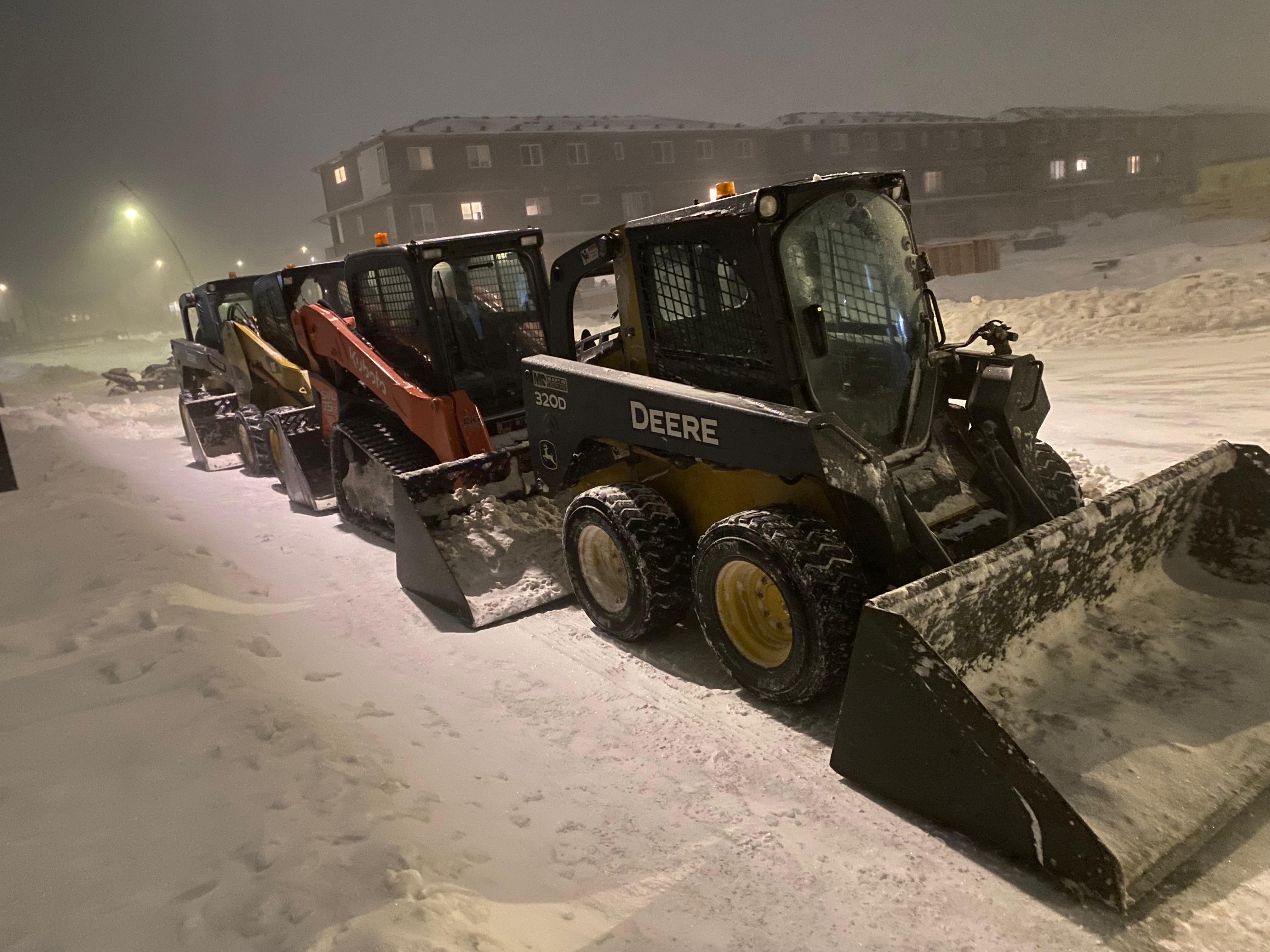ALA Landscaping snow removal fleet - three machines deployed at night during Edmonton storm